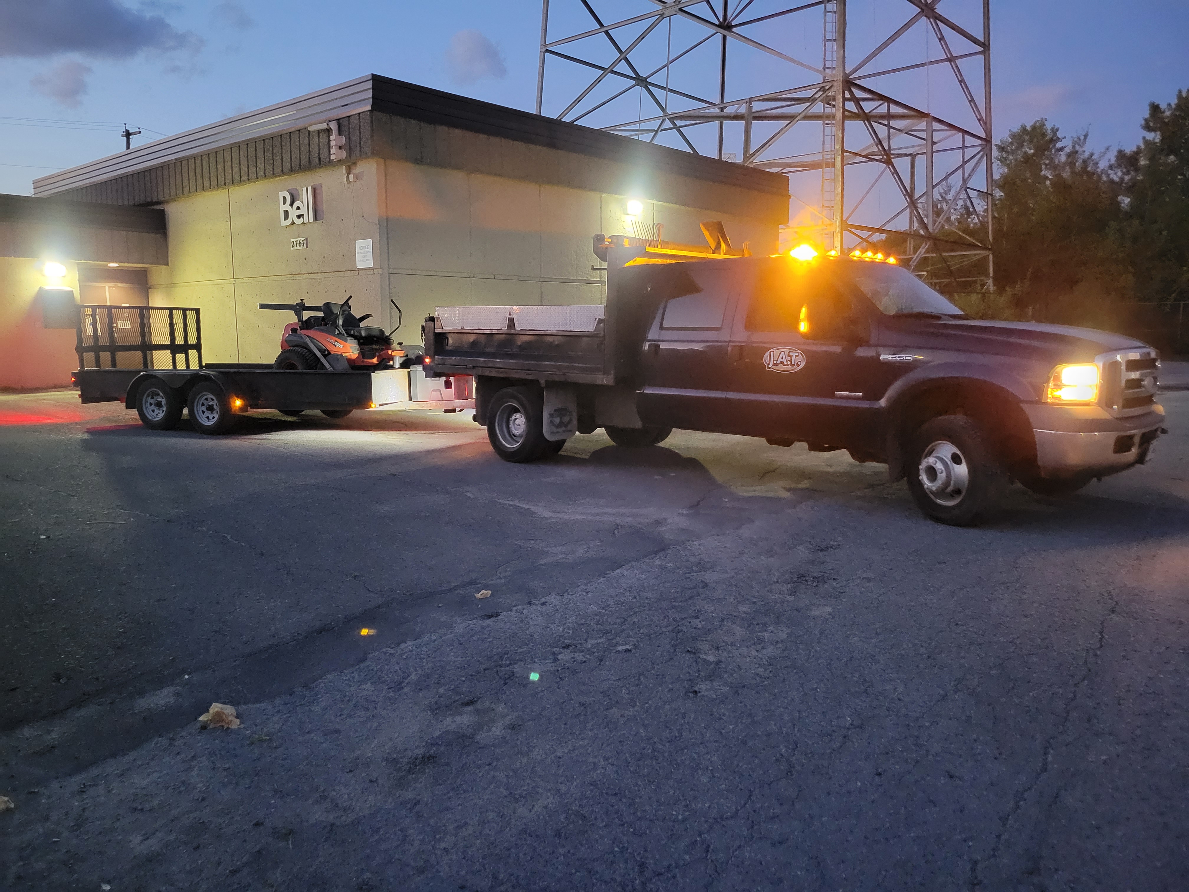 Truck with mower at night